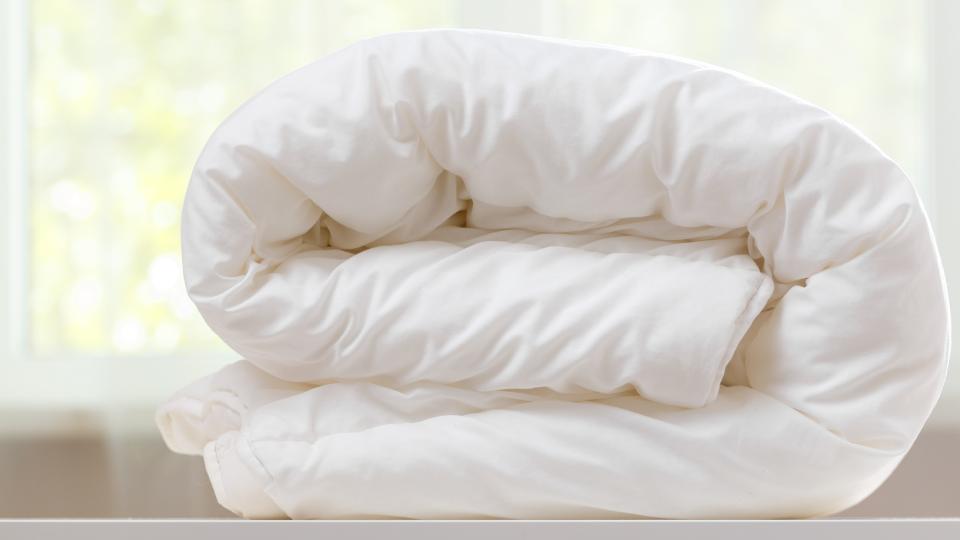 a wrapped up duvet being thrown in the bin