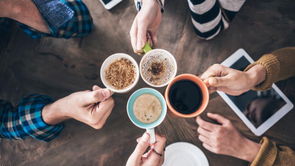 customers in a cafe with different types of coffee including latte, cappuccino and americano