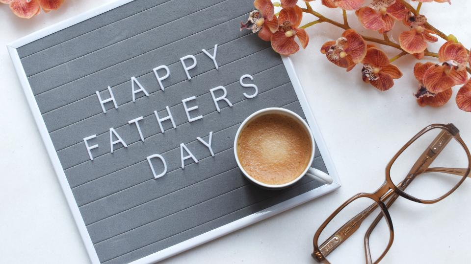 A pinboard that has the letters spelled out to say HAPPY FATHERS DAY.