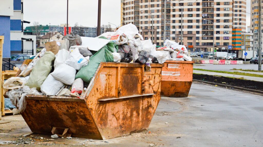 two yellow filled skips
