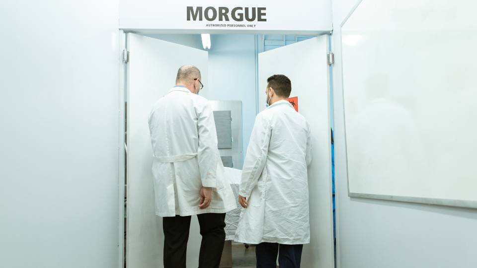 Two doctors going into a morgue in a funeral home