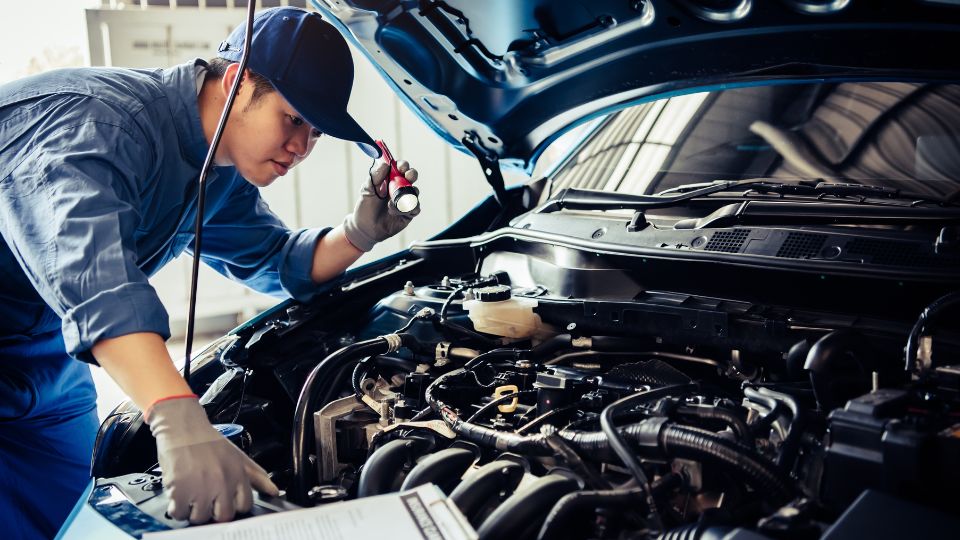 a car technician testing chemicals in an engine