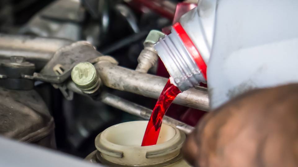 red chemical from a garage in the UK going into an engine