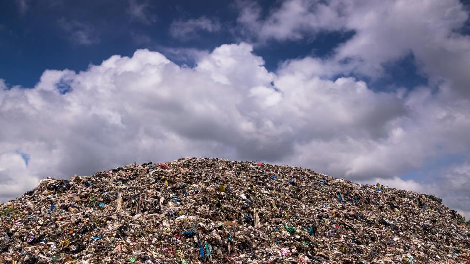 a cloudy sky with a landfill site.