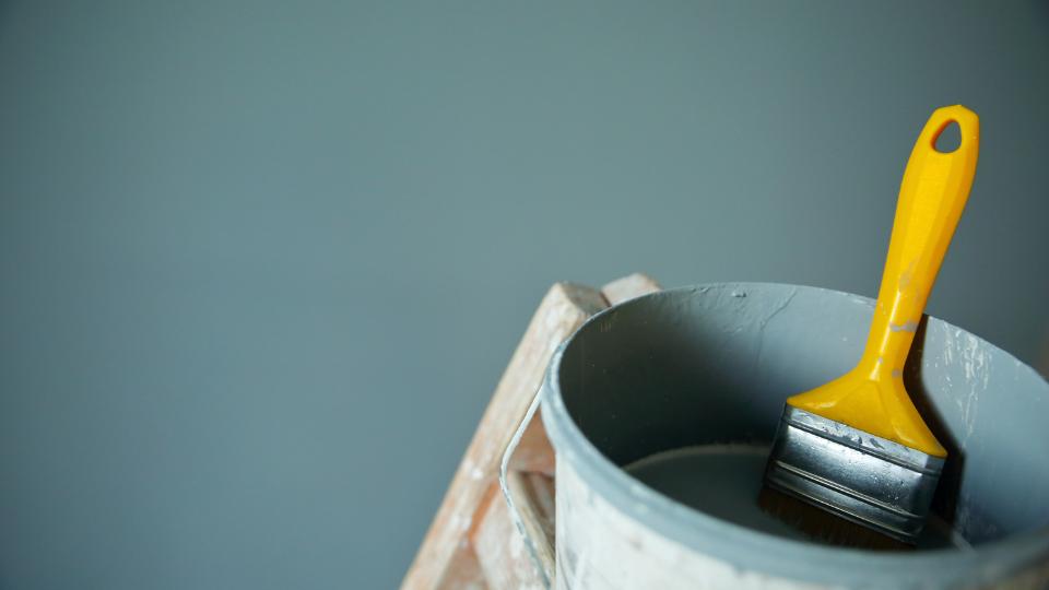 Paint container and brush on a step ladder